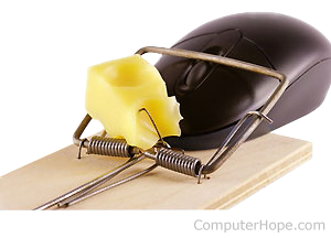 Computer mouse trapped in a mouse trap with cheese.